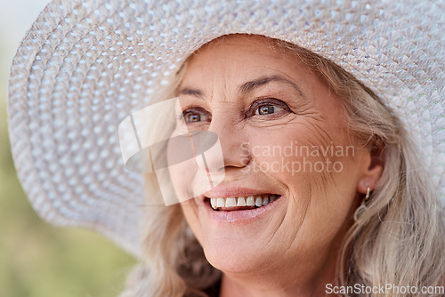 Image of Happiness is permanent on her face. Cropped shot of an attractive senior woman smiling while standing outdoors on a summers day.