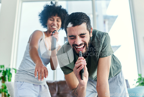 Image of He knows that I always have his back. Cropped shot of a couple having a sing along at home.