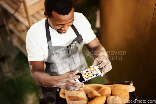 Image of Do something that youre proud of. Cropped shot of a male baker taking a picture on his cellphone of a selection of freshly baked bread.