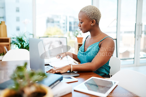 Image of Make every minute of the workday count. Shot of a young businesswoman working at her desk in a modern office.