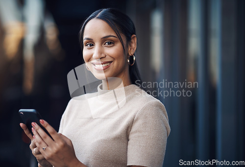 Image of Ive just gotta send this message quickly. Cropped portrait of an attractive young businesswoman sending a text while working in her office.