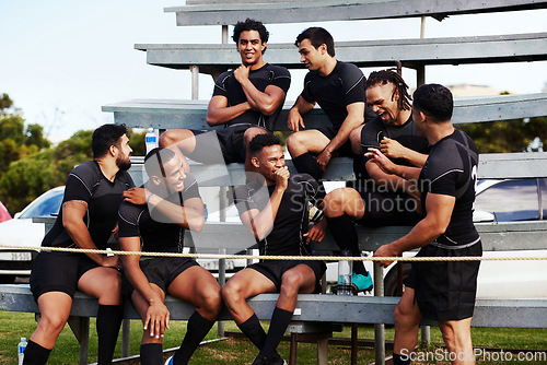 Image of Action isnt just reserved for the field. Shot of a group of young men sitting on the benches together at a rugby game.