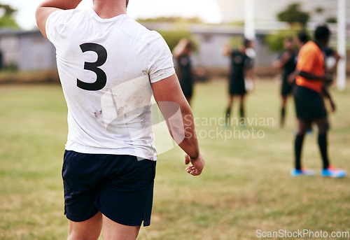 Image of Lifes short, spend it on a rugby field. Cropped shot of a man playing a game of rugby with his teammates in the background.