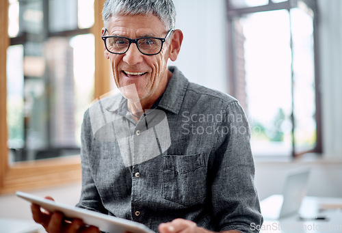 Image of Technology always inspires me with new ideas. Portrait of a senior businessman using a digital tablet in an office.