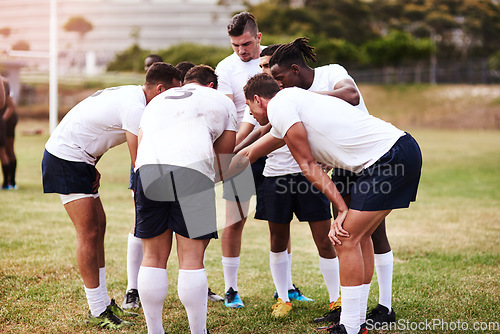 Image of Its tough to beat a team that plays together. Shot of a group of young men joining their hands in solidarity before playing a game of rugby.