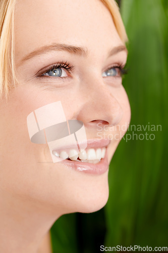Image of She has such a pure beauty. Headshot of a beautiful young woman against a leafy green background.