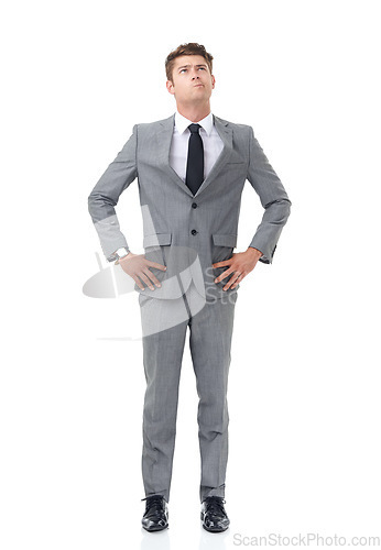 Image of Ready to climb the corporate ladder. A young businessman standing with his hands on his hips looking upwards.