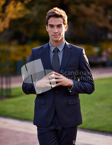 Image of The future is looking bright. Portrait of a handsome and stylish businessman standing in a city park.