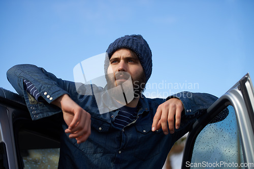 Image of Ready to go on an adventure. A man with facial hair leaning on his car door.