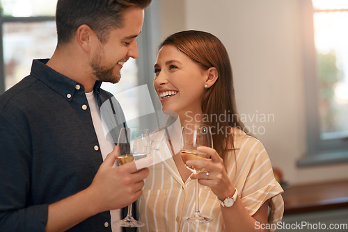 Image of Drink some wine and just relax. Cropped shot of a young couple having wine at home.