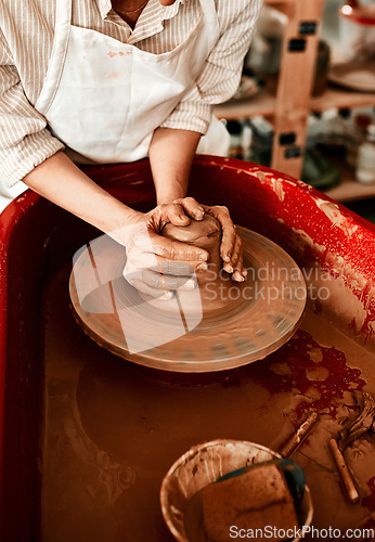 Image of Clay is one of the easiest mediums to work with. Cropped shot of an unrecognizable woman molding clay on a pottery wheel.