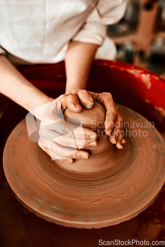 Image of Creating things with my hands is what I love most. Cropped shot of an unrecognizable woman molding clay on a pottery wheel.