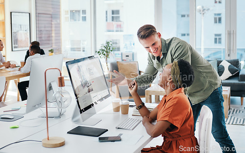 Image of When great minds come together, so do great things. Cropped shot of two young business colleagues having a discussion and working on a computer together in the office.