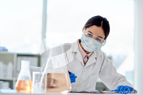 Image of Conducting another careful experiment. Shot of a young scientist doing an experiment in a lab.