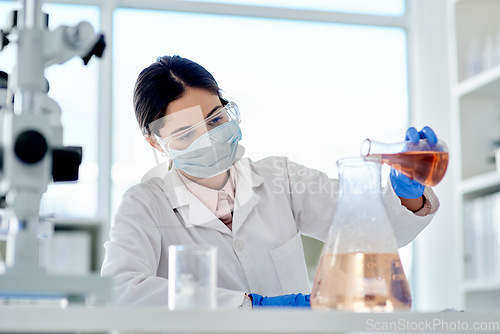 Image of I hope this reacts as I expect it to. Shot of a young scientist doing an experiment in a lab.