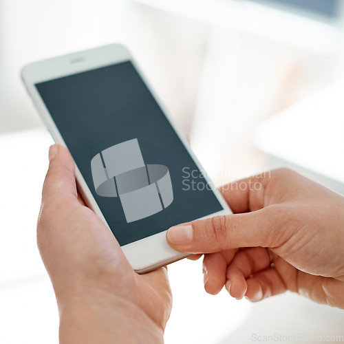 Image of Instant messaging suits her business needs. Cropped shot of an unrecognizable businesswoman using her smartphone inside of an office.