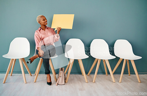 Image of Thats lovely news. Studio shot of an attractive young businesswoman holding up a speech bubble while siting in line against a grey background.