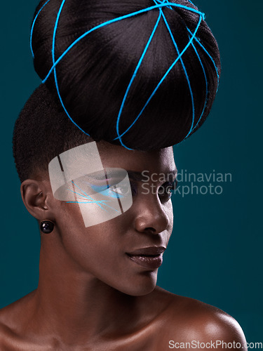 Image of Idea, fashion and hair care with a model black woman in studio on a blue background for beauty. Thinking, makeup and cosmetics with an attractive young female person at a salon for a trendy hairstyle