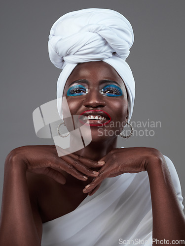 Image of Shes a true African queen. Studio shot of an attractive young woman posing in traditional African attire against a grey background.