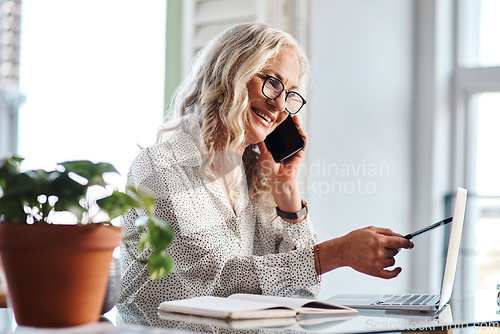 Image of I have that right here...Cropped shot of an attractive senior businesswoman taking a phonecall while working from home.