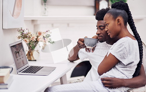 Image of My test results should pop up anytime now...Shot of a young couple using a laptop while sitting together at home.