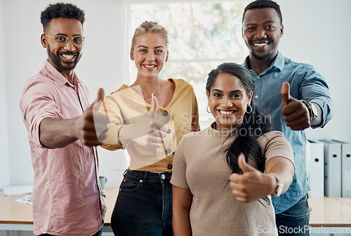 Image of Climbing our way up the business ladder. Cropped portrait of a diverse group of businesspeople standing together and making a thumbs up gesture in the office.