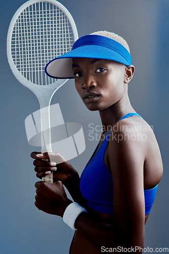 Image of You are what you do So do GREAT things. Studio shot of a sporty young woman posing with a tennis racket against a grey background.