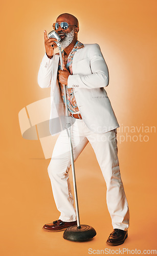 Image of Be whatever you want to be. you might inspire others. Studio shot of a senior man wearing vintage clothes while singing into a microphone.