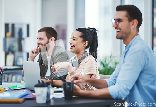 Image of Optimism helps us persevere and conquer. Shot of a group of young designers listening to a presentation in an office.