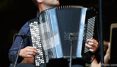 Image of Accordion harmony. Cropped closeup shot of a musician playing an accordian.