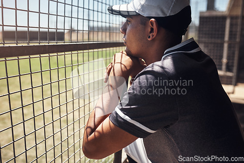 Image of Nothing hypnotises him like baseball. Shot of a young man watching a game of baseball from behind the fence.