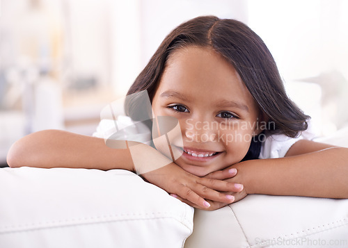 Image of She knows shes adorable. Cropped portrait of a little girl lying on the sofa at home.