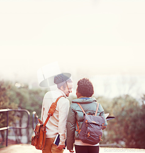 Image of Young love. Rearview shot of an affectionate young couple on campus.