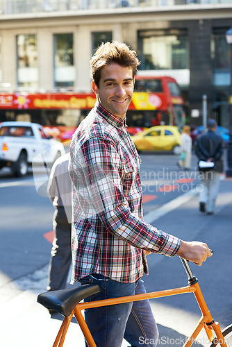 Image of Feeling good about this day. Portrait of a handsome man traveling by bicycle in the city.
