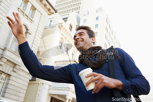 Image of I havent seen you in years. Low angle shot of a man drinking a coffee and greeting someone in the city.