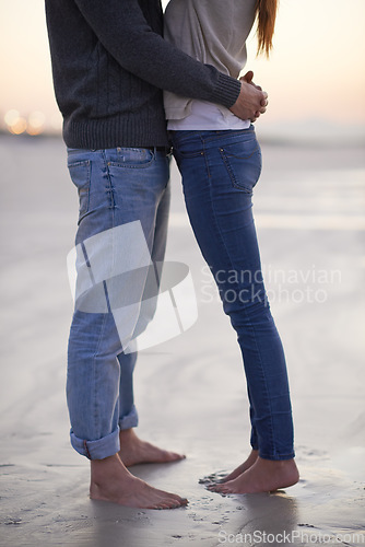 Image of Love at the beach. A young couple enjoying each others company at the beach.