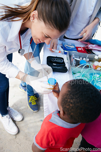 Image of Donating her time and medical expertise to her community. Shot of a volunteer doctor giving checkups to underprivileged kids.