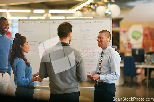 Image of Success is reason enough to smile. Cropped shot of a group of businesspeople talking in the boardroom.