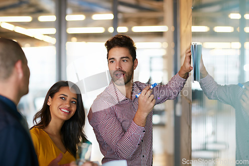 Image of Hes on top of things. Cropped shot of three businesspeople working in the office.