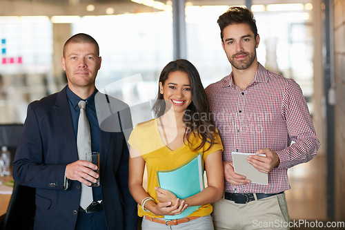 Image of Teamwork is how well achieve success. Cropped portrait of three businesspeople standing in the office.