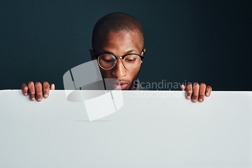 Image of Oh really. Cropped shot of a man standing behind a blank placard.