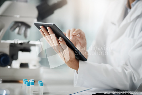 Image of Making a record of her research. Cropped shot of an unrecognizable mature female scientist using a tablet while doing research in her lab.
