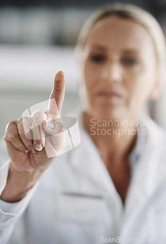 Image of She pushes all the right buttons. Cropped shot of a mature female scientist working on touchscreen technology while doing research in her lab.