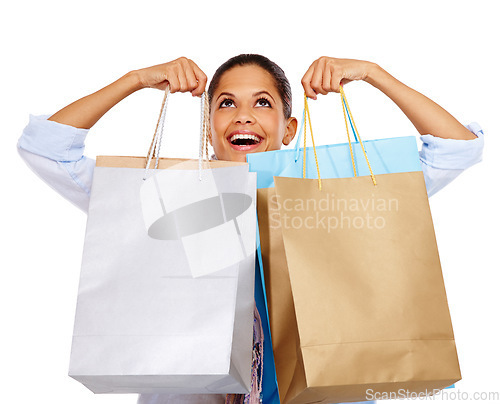 Image of Woman, shopping bags and smile for store sale, discount or deal against white studio background. Happy isolated female shopper smiling holding gift bags for retail shopping spree on white background