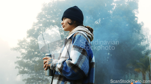 Image of Thinking, nature and a woman with coffee on vacation, relax and camping in the woods. Calm, idea and a young girl drinking tea in the morning in a forest during a holiday in winter for travel