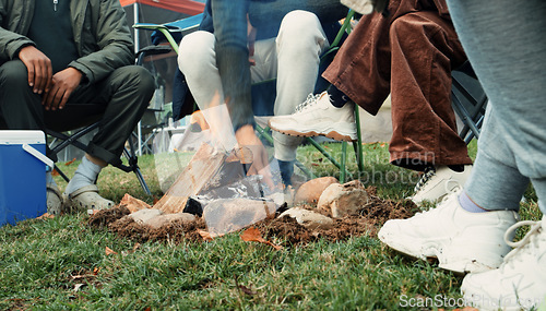 Image of Wood, fire and warm hands on camping, trip or adventure in nature, forest or friends together at a bonfire in winter. Campfire, smoke and group relax on outdoor vacation, holiday or warming hand