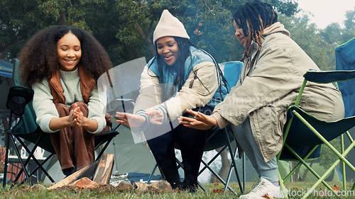 Image of Friends camping, fire and warm hands with flame on trip or adventure in nature, forest or together at a bonfire in winter. Campfire, smoke and group relax on outdoor vacation, holiday or warming hand