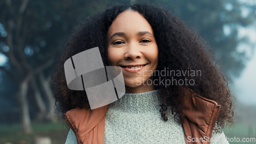 Image of Portrait, face and a happy woman outdoor in nature to relax and breathe fresh air. Vacation, calm woods and closeup of a young african girl on holiday or hike on misty morning with a confident smile