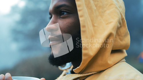 Image of Coffee, morning and black man hiking in the woods with a blurred background of cold, winter weather. Thinking, raincoat and face of a young male hiker in the forest or nature to explore for adventure