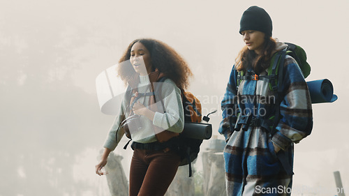 Image of Travel, backpack and friends hiking in the mountain on a cold, overcast morning in nature together. Travel, freedom and adventure with women walking in the wilderness to explore while bonding